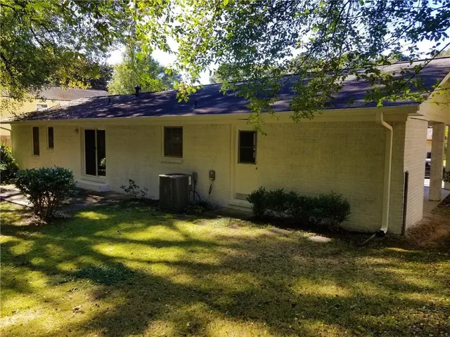 a view of a house with pool and sitting area