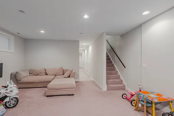 a living room with furniture and stairs