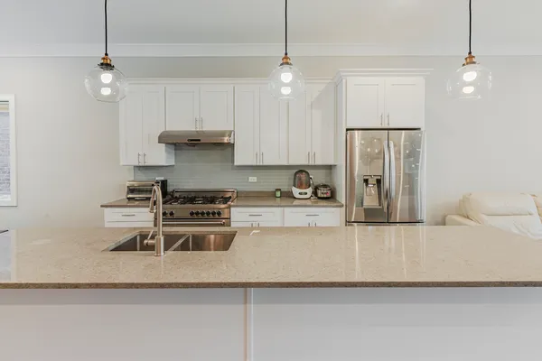 a kitchen with a refrigerator and a stove