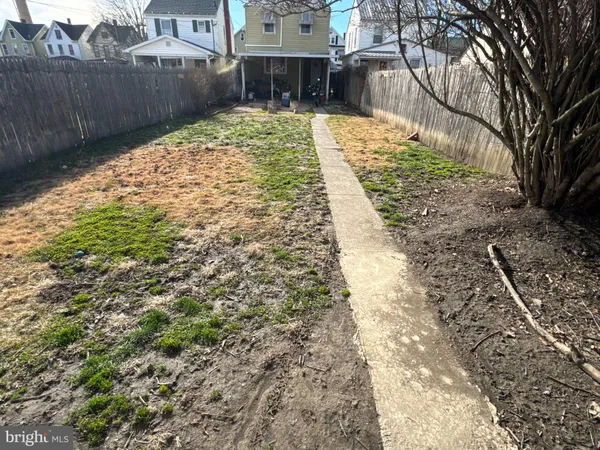 a view of yard with wooden fence