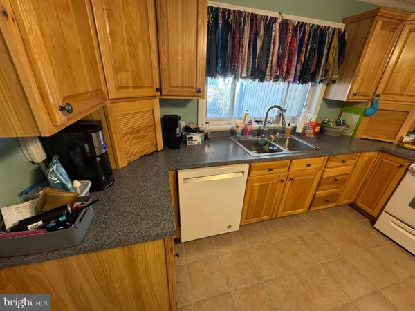 a view of a kitchen with sink and cabinets