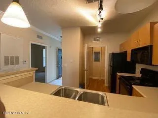 a spacious bathroom with a sink a large mirror and a shower