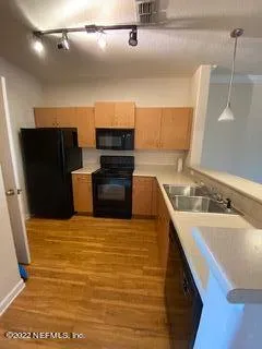 a kitchen with stainless steel appliances granite countertop a sink and a stove