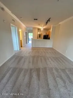 a view of a big room with wooden floor and windows