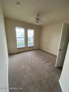 an empty room with windows and entrance