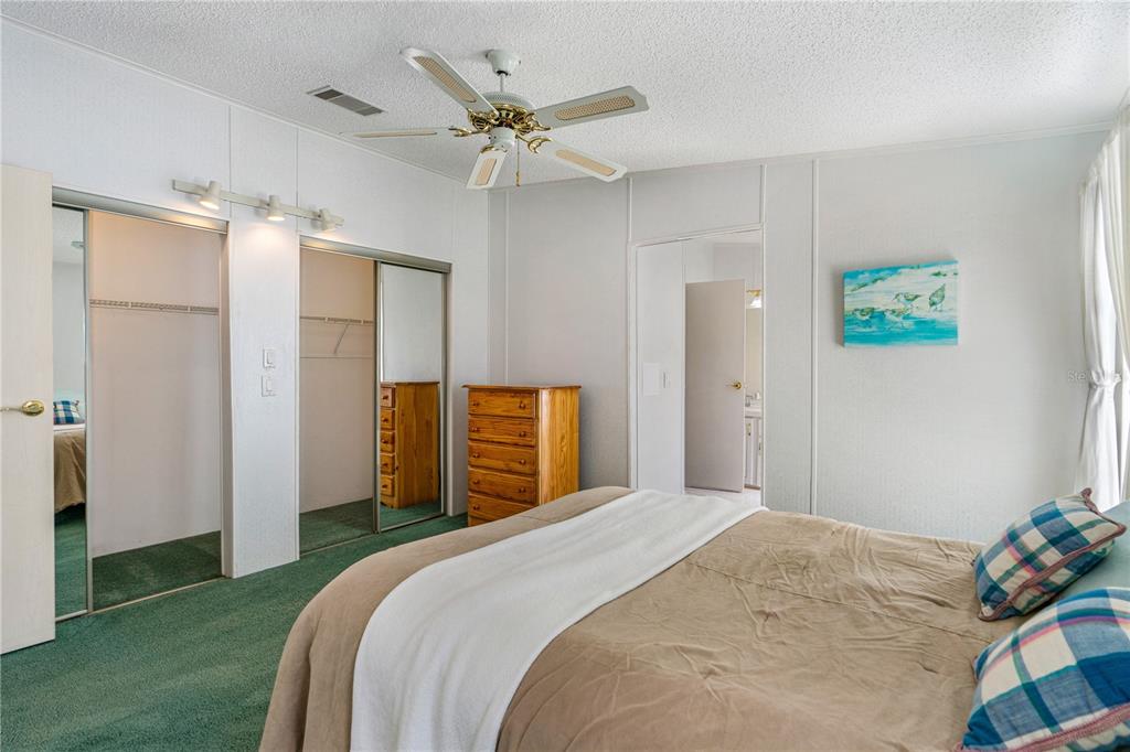 509 Starboard Avenue Edgewater, FL 32141 - Photo 19 of 54 a bedroom with a bed and a chandelier