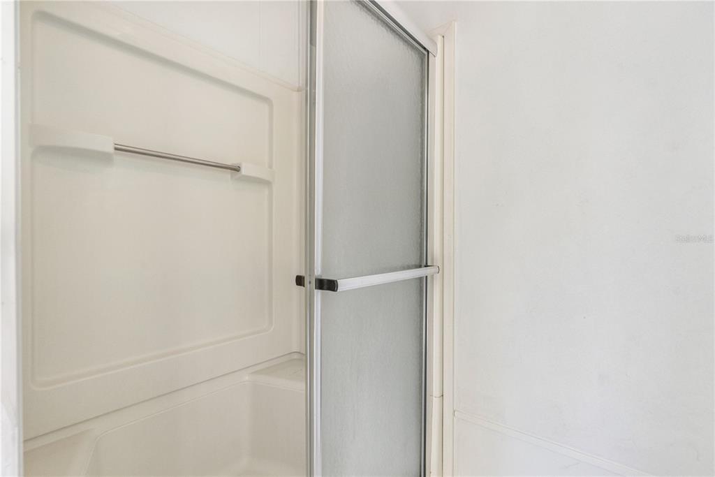 509 Starboard Avenue Edgewater, FL 32141 - Photo 22 of 54 a bathroom with a glass shower door