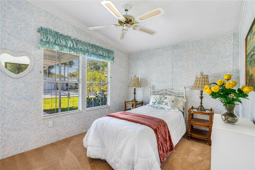 509 Starboard Avenue Edgewater, FL 32141 - Photo 26 of 54 a bedroom with a bed and a chandelier