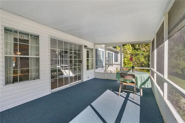 a backyard of a house with plants and large trees