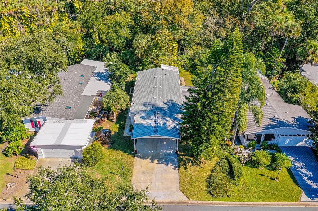 509 Starboard Avenue Edgewater, FL 32141 - Photo 35 of 54 an aerial view of a house with a yard and trees all around