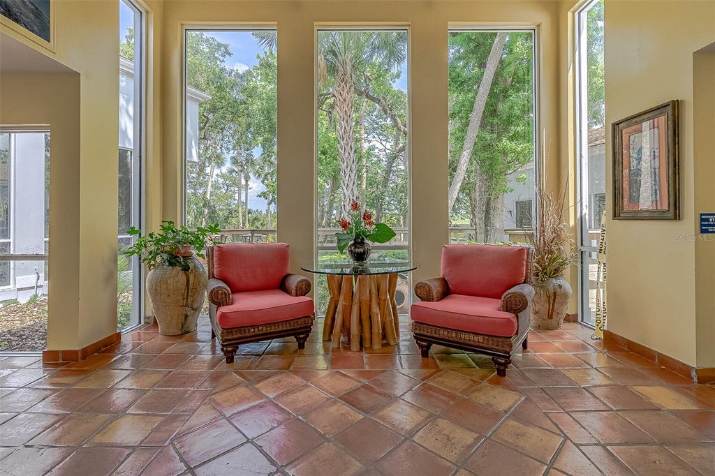 509 Starboard Avenue Edgewater, FL 32141 - Photo 39 of 54 a living room with furniture and a floor to ceiling window