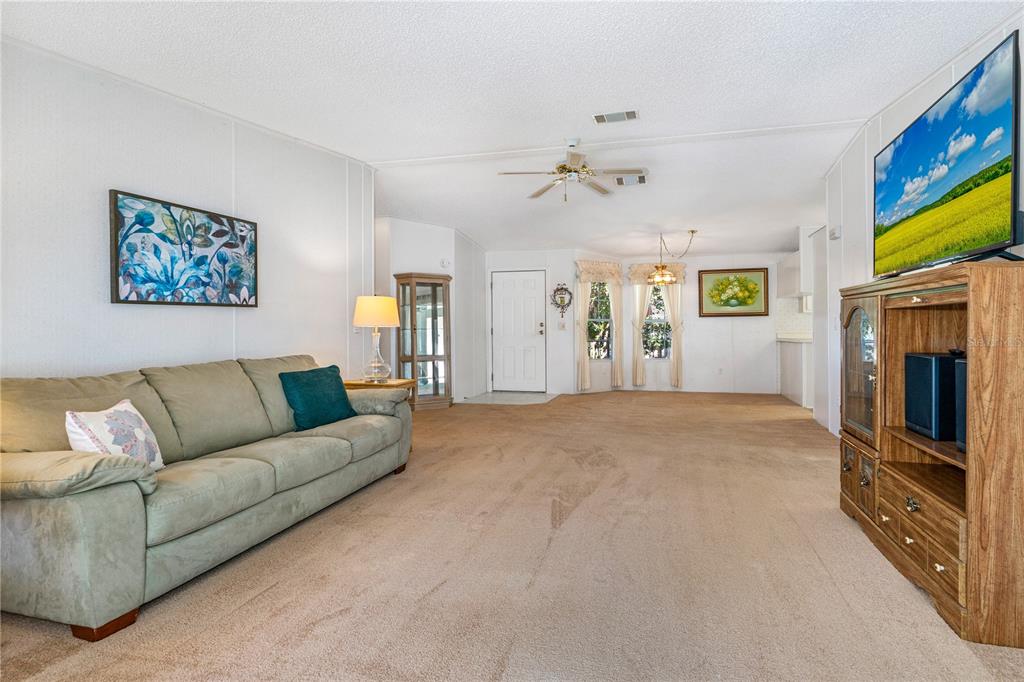 509 Starboard Avenue Edgewater, FL 32141 - Photo 10 of 54 a living room with furniture a flat screen tv and a fireplace