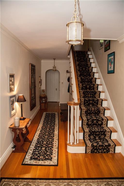 312 Harmony Road Pittsburgh, PA 15237 - Photo 5 of 25 The center entry hall invites you in with the living room to the left and dining room to the right. powder room is all the way to the rear with the den/office to the left and kitchen and screened porch to the right.