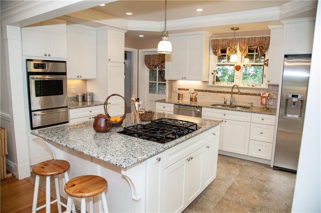 312 Harmony Road Pittsburgh, PA 15237 - Photo 8 of 25 Work areas that cabinetry that make working in the kitchen a pleasure. Island seating, beautiful finishes and details. Rear door to screened porch and rear hall.