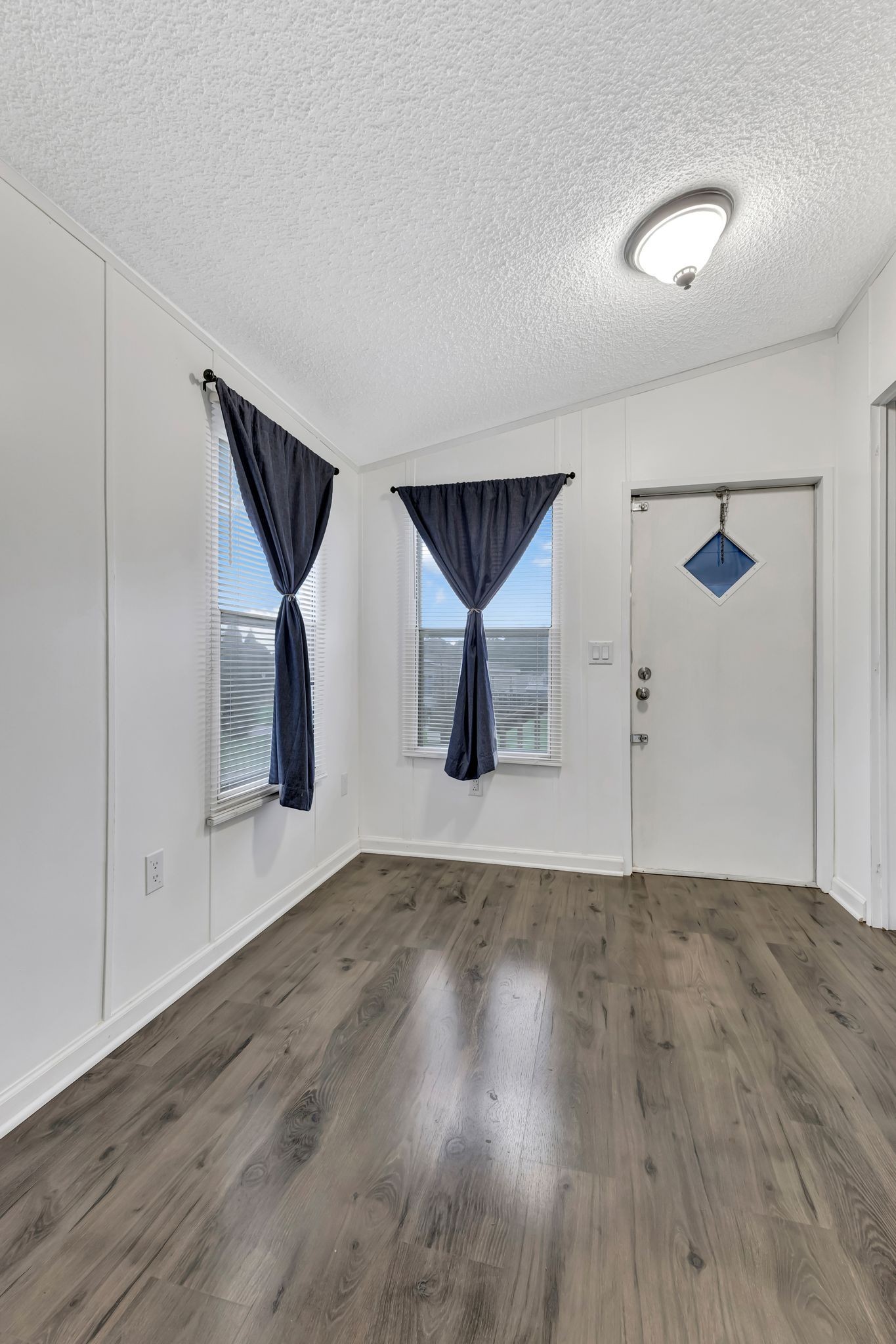9440 Missionary Ridge Road Bon Aqua, TN 37025 - Photo 18 of 59 an empty room with wooden floor and windows