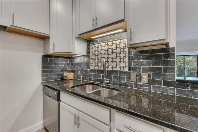 a kitchen with a sink and cabinets