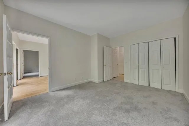 a view of an empty room and closet area