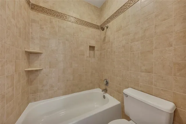 a bathroom with a toilet and bathtub