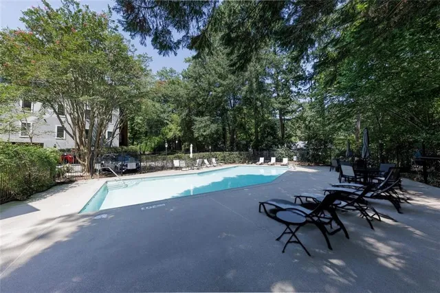 a swimming pool with outdoor seating and yard