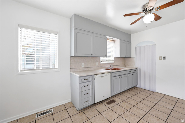 676 South 500 West Provo, UT 84601 - Photo 7 of 29 Kitchen featuring light countertops, ceiling fan, dishwasher, light tile patterned floors, and gray cabinetry