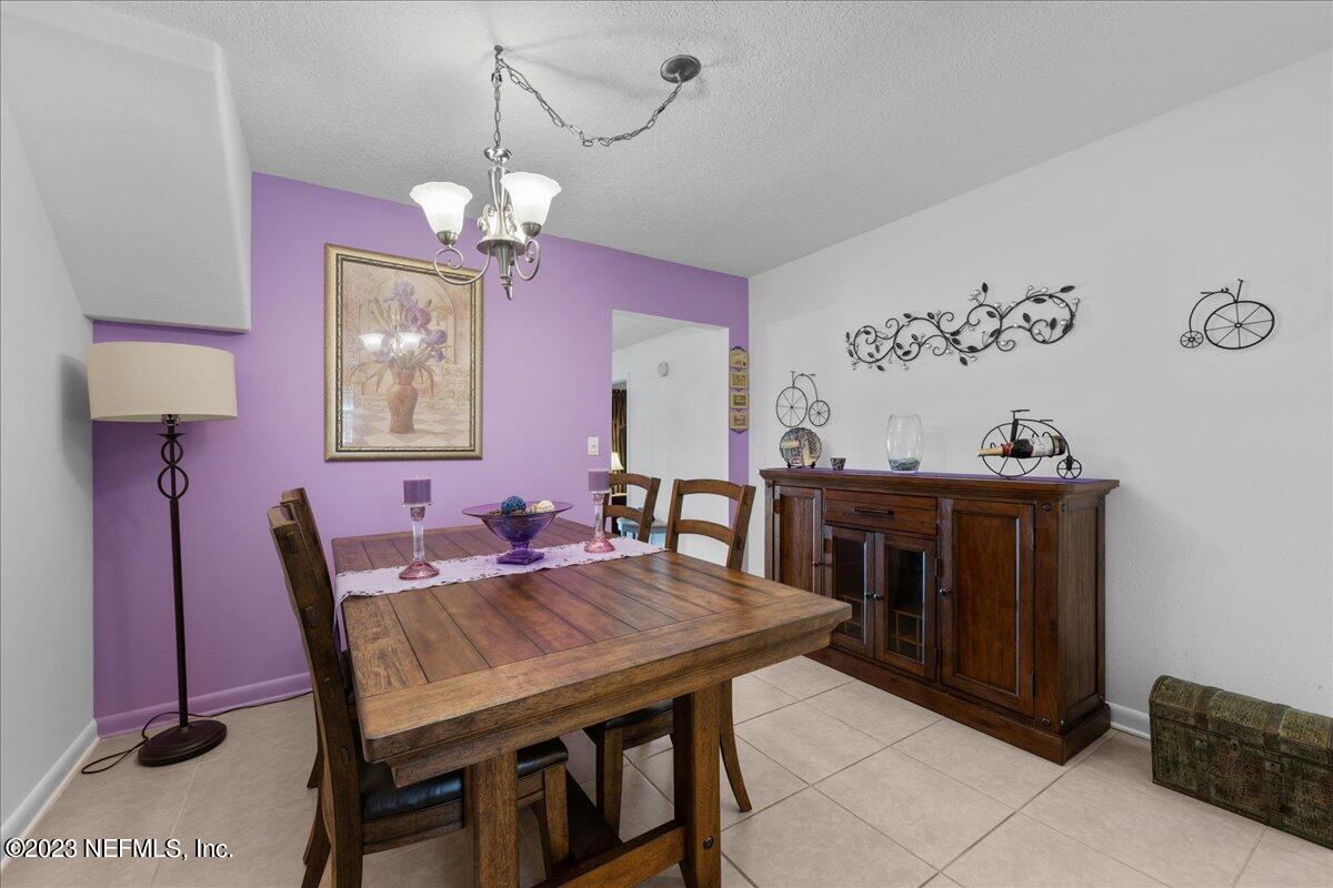 113 Leaf Street San Mateo, FL 32187 - Photo 12 of 32 a view of a dining room with furniture and chandelier