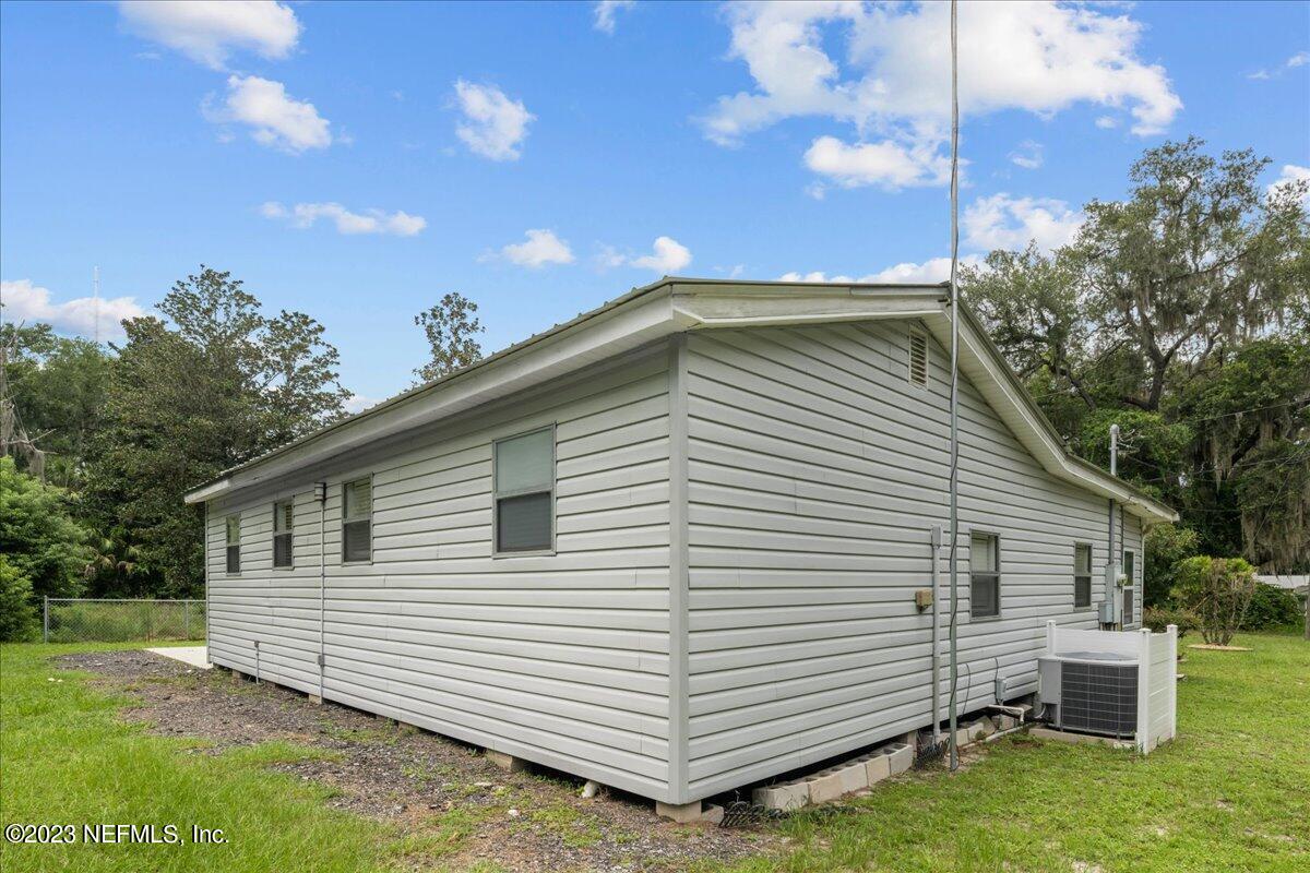 113 Leaf Street San Mateo, FL 32187 - Photo 17 of 32 a view of a white house with a yard and table and chairs