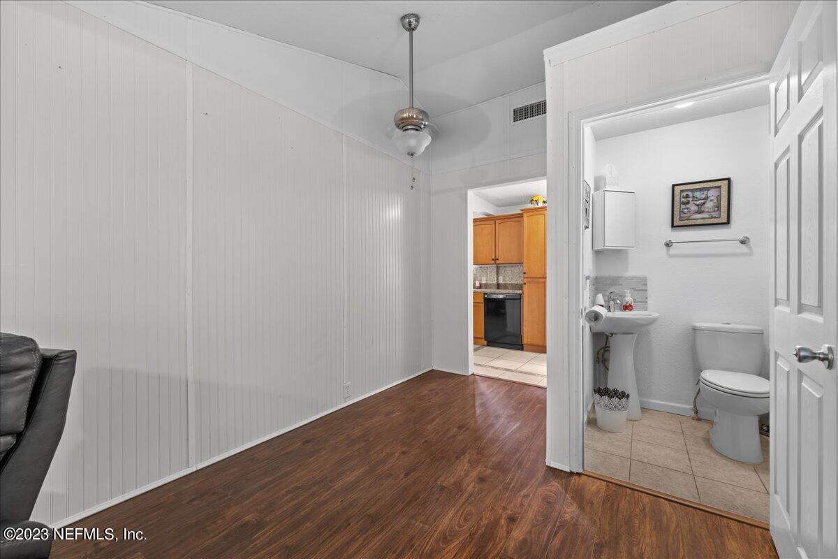 113 Leaf Street San Mateo, FL 32187 - Photo 25 of 32 a view of bathroom with a toilet a sink and wooden floor