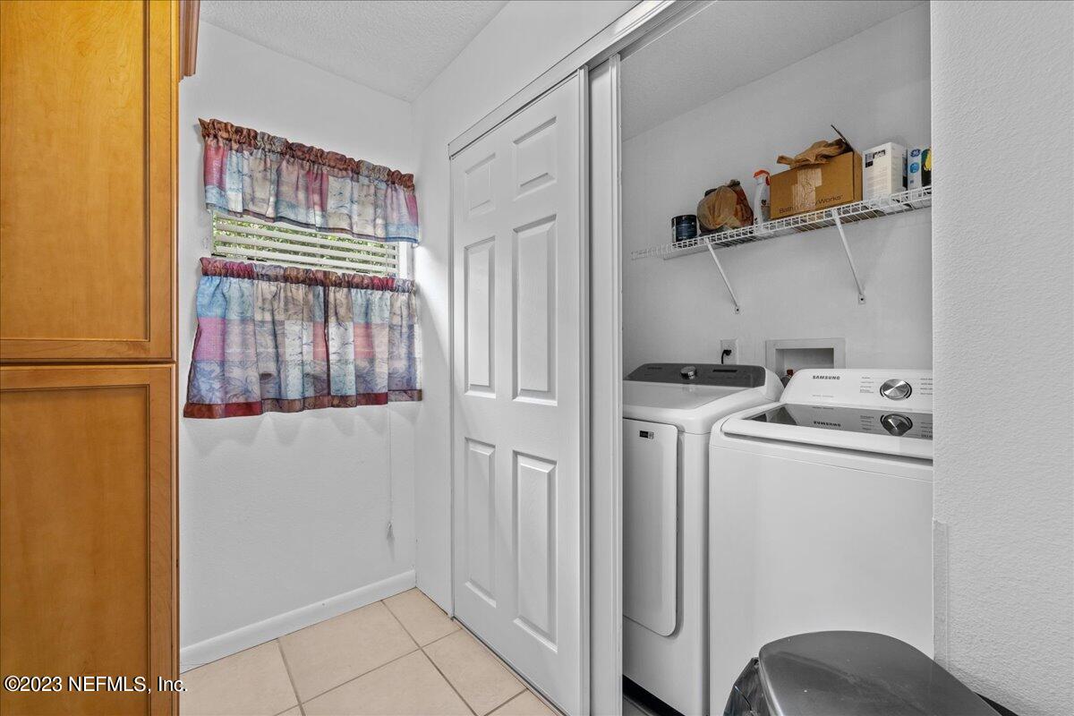 113 Leaf Street San Mateo, FL 32187 - Photo 27 of 32 a view of storage and utility room with washer and dryer