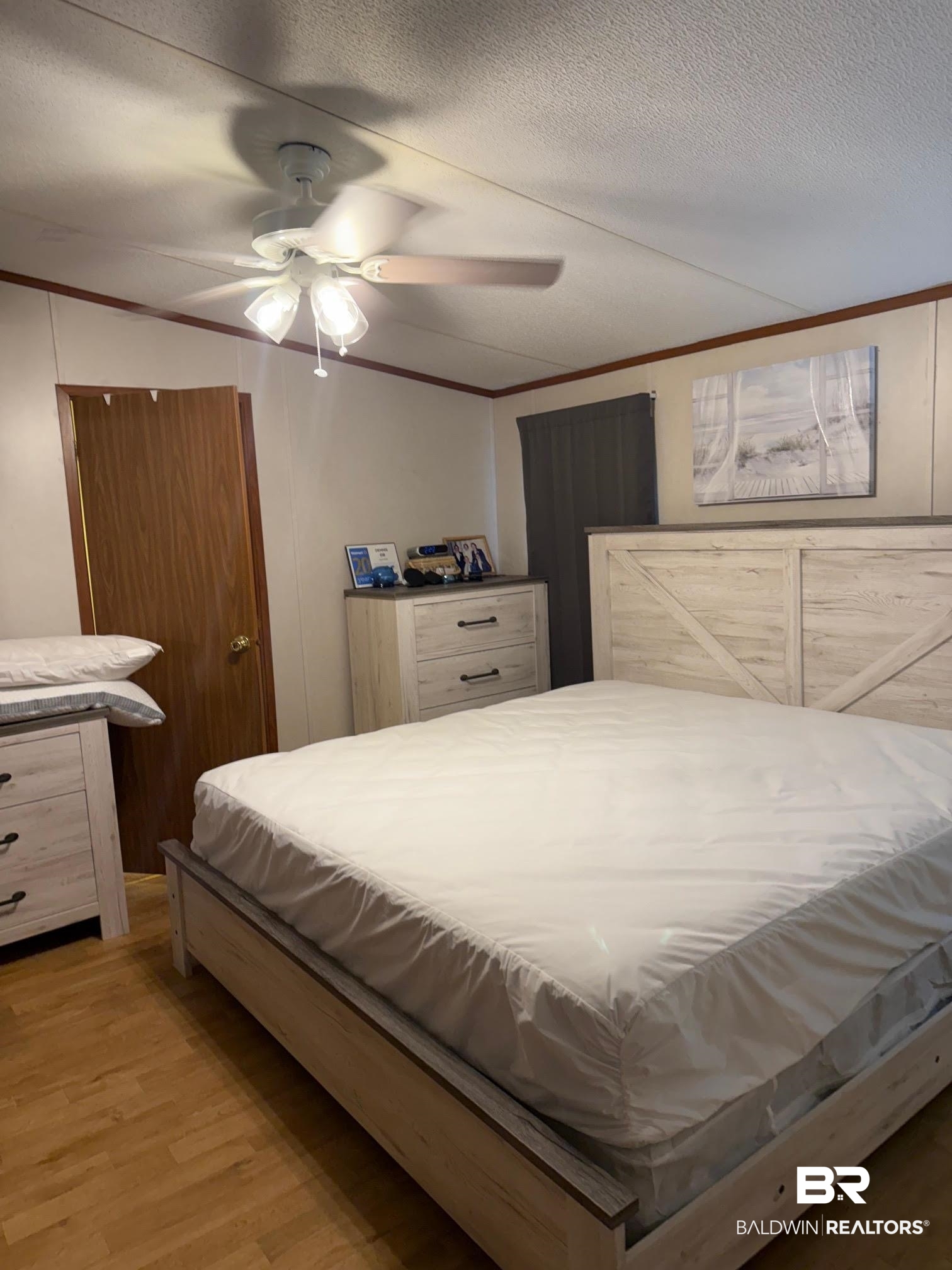 15844 County Road 87 Elberta, AL 36530 - Photo 24 of 28 Bedroom with a textured ceiling, crown molding, light wood-type flooring, and ceiling fan