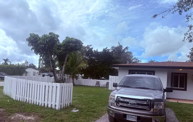 a backyard of a house with table and chairs