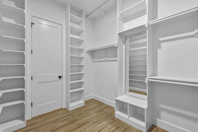 a view of walk in closet with empty racks