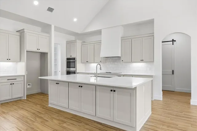 a kitchen with stainless steel appliances granite countertop a sink and cabinets
