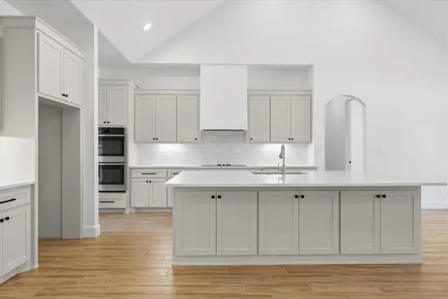 a kitchen with stainless steel appliances granite countertop a sink and cabinets