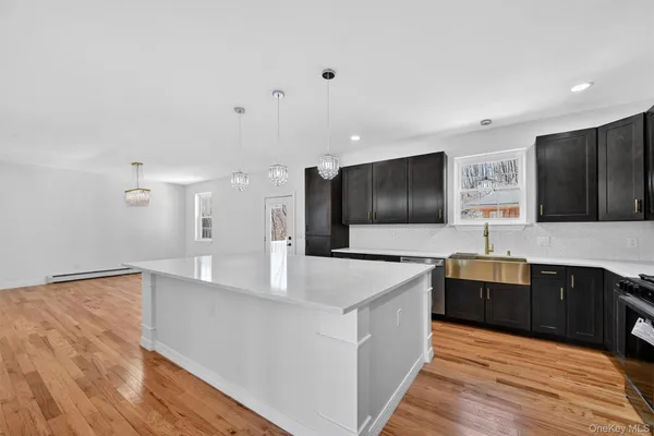 a large kitchen with stainless steel appliances a large counter top and a stove