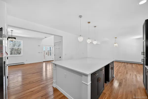 a view of a room with wooden floor and white walls