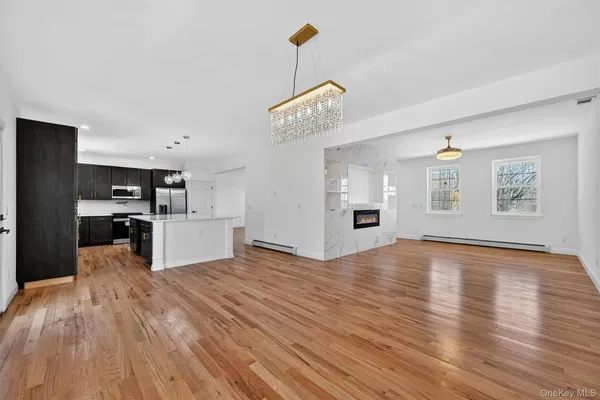a view of a kitchen with wooden floor and a kitchen