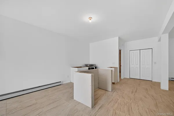 a view of a kitchen with refrigerator and wooden floor