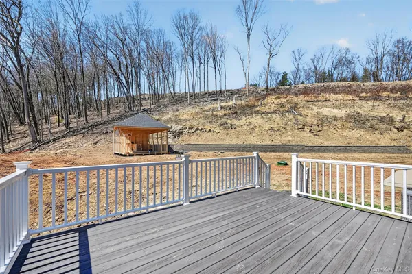 a view of a backyard with wooden fence