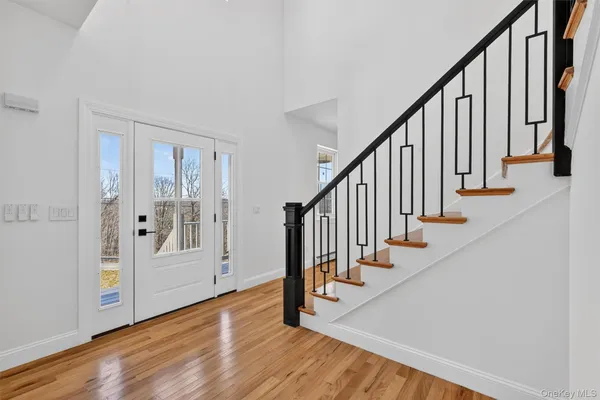 a view of an entryway with wooden floor and door