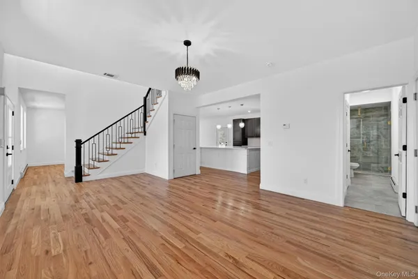 a view of entryway and hall with wooden floor