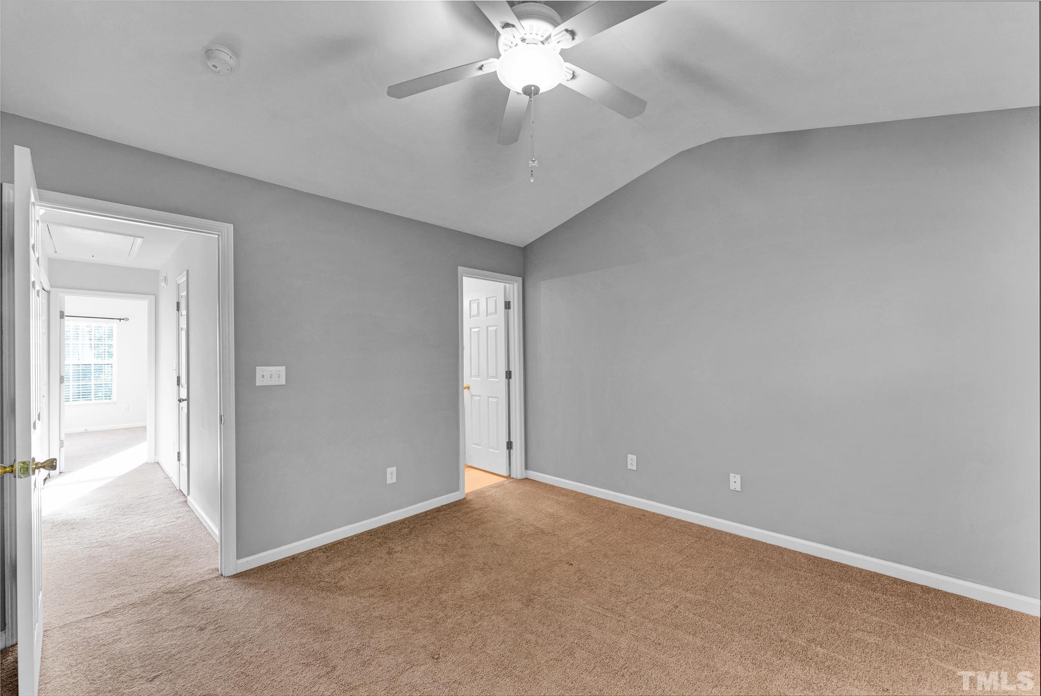 1612 Brook Fern Way Raleigh, NC 27609 - Photo 8 of 14 an empty room with chandelier fan and windows