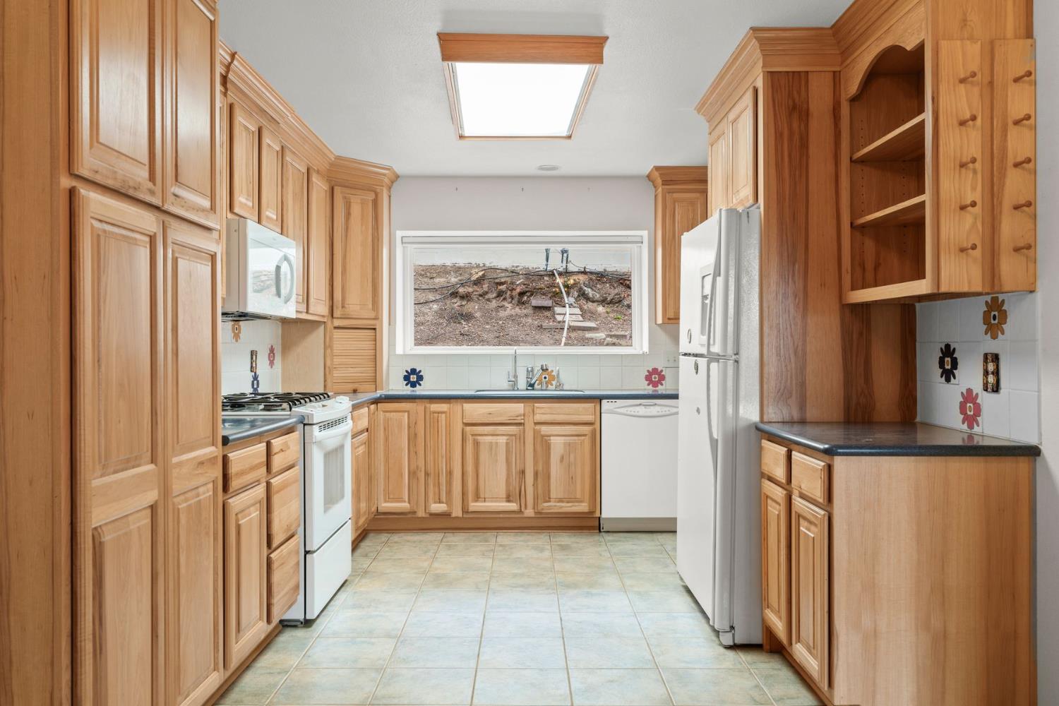 25 Hill Street Oak View, CA 93022 - Photo 5 of 16 a kitchen with stainless steel appliances granite countertop a stove and a refrigerator