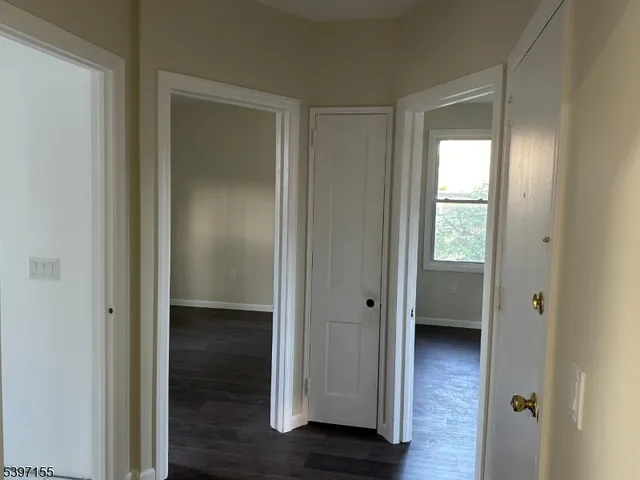 a view of a bathroom with a glass door and a wooden floor