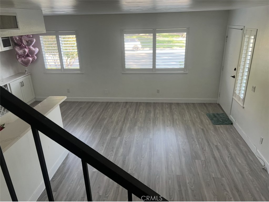1301 West 8th Street Upland, CA 91786 - Photo 12 of 12 a view of an empty room with wooden floor and a window