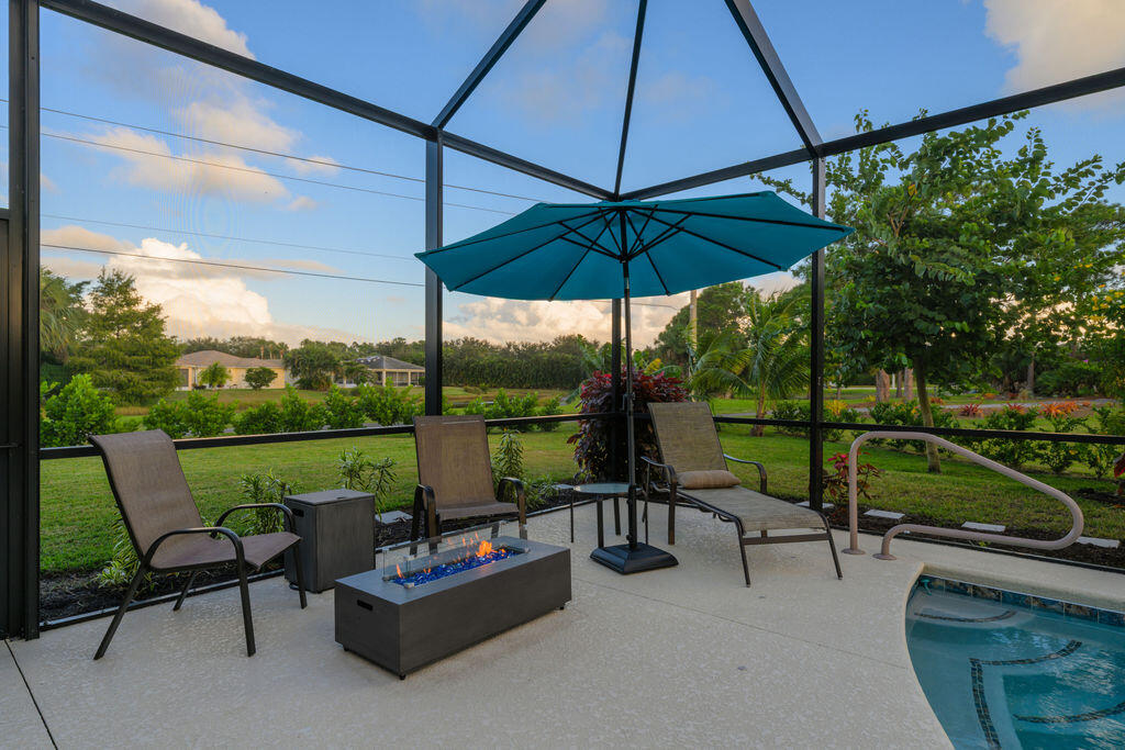 1155 Southwest Bent Pine Cove Port St. Lucie, FL 34986 - Photo 21 of 25 Fire pit sitting area