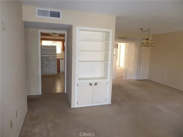 an empty room with closet and wooden door
