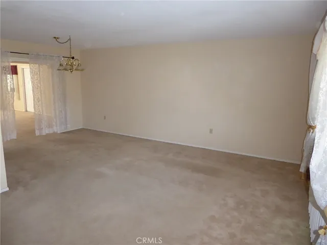 en empty room with windows and cabinet