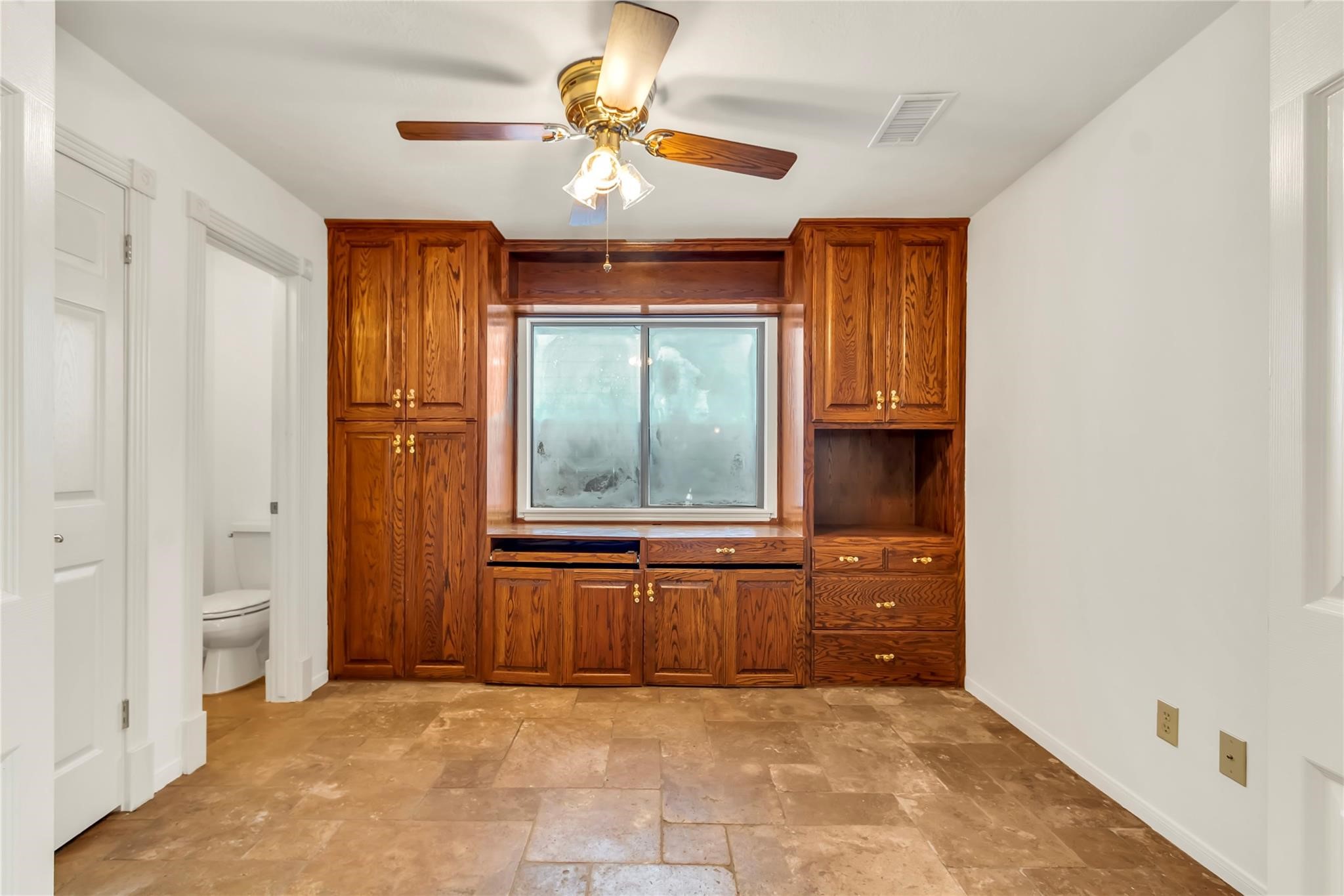2311 Peppermill Road Houston, TX 77080 - Photo 11 of 18 an empty room with windows and cabinet
