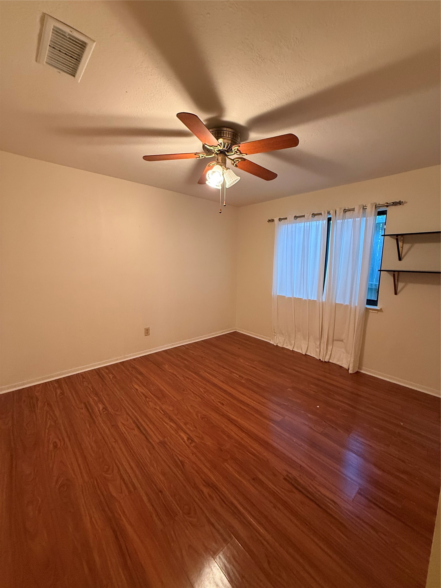 2311 Peppermill Road Houston, TX 77080 - Photo 12 of 18 a view of a room with wooden floor and a ceiling fan