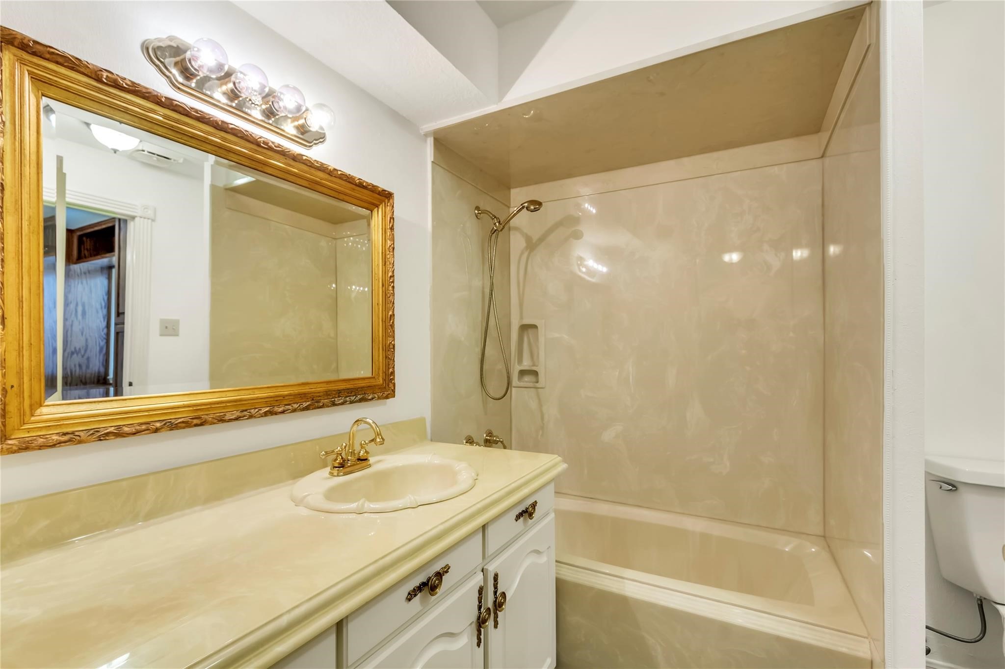 2311 Peppermill Road Houston, TX 77080 - Photo 14 of 18 a bathroom with a sink and a mirror